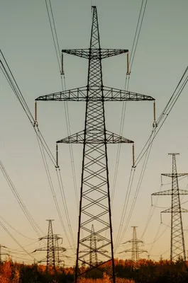 High-voltage power lines at dusk — energy sector